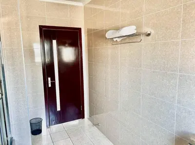 a bathroom with a shower with a black door at Euoren Living in Midrand