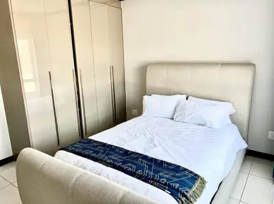 a bed with white sheets and pillows in a room at Euoren Living in Midrand