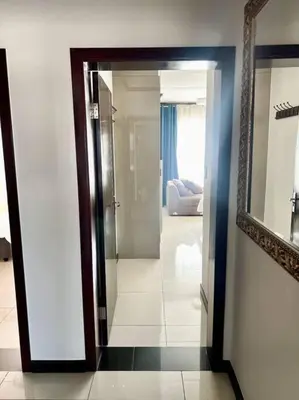 a doorway to a room with a mirror and a living room at Euoren Living in Midrand