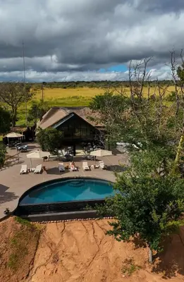 an overhead view of a swimming pool in front of a building at Honeyguide Conservation Lodge in Golders Green