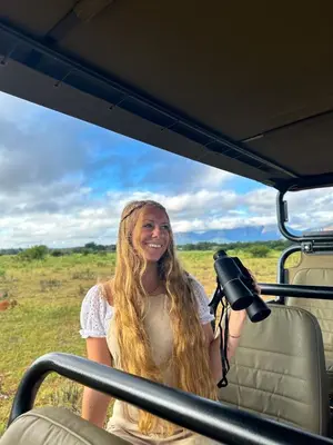 a woman sitting in the back of a vehicle at Honeyguide Conservation Lodge in Golders Green