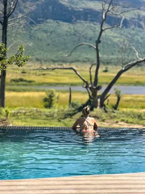 a man in the water in a pool of water at Honeyguide Conservation Lodge in Golders Green