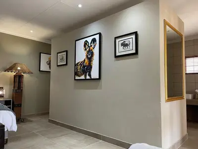 a bedroom with two framed pictures on the wall at Mountain Dew Guest House in Noordkaap