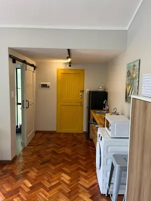 a kitchen with a stove and a yellow door at Apartments on Herbert Baker in Pretoria