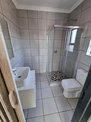 a bathroom with a shower and a toilet and a sink at Kanyamazane Guesthouse 1214 in eNyamazaneni