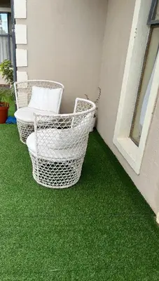 two baskets on a balcony with green grass at 17 Byvanger Luxury Home Deluxe King Suite Room 3 in Centurion