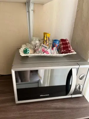 a microwave with a tray on top of it at 17 Byvanger Luxury Home Deluxe King Suite Room 3 in Centurion