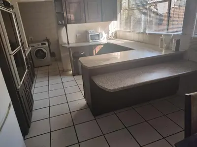a small kitchen with a sink and a microwave at Escape in Pretoria