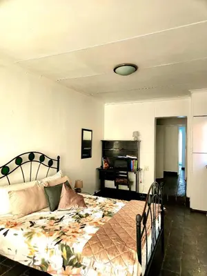 a bedroom with a large bed and a piano at Escape in Pretoria