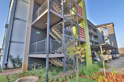 a building with stairs on the side of it at Lowveld Vivid Haven in Boschrand