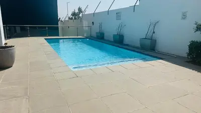 a swimming pool on the side of a building at Anna Suite - Serenity & Stuff Luxury Apartments in Midrand