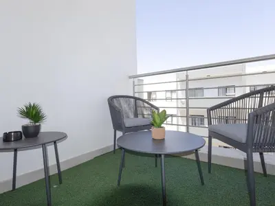 a room with two chairs and two tables with plants at Anna Suite - Serenity & Stuff Luxury Apartments in Midrand