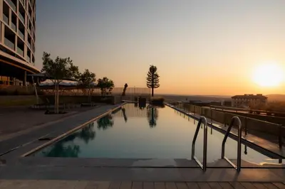 a swimming pool with the sunset in the background at Ellipse Executive Haven in Midrand