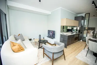 a living room with a white couch and a table at Ellipse Executive Haven in Midrand
