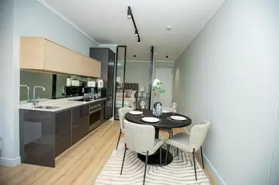 a kitchen with a table and chairs in a room at Ellipse Executive Haven in Midrand