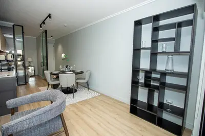 a dining room with a table and chairs and a kitchen at Ellipse Executive Haven in Midrand