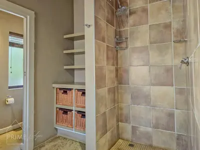 a bathroom with a shower with a glass door at Rhino Lodge at Zebula in Mabula