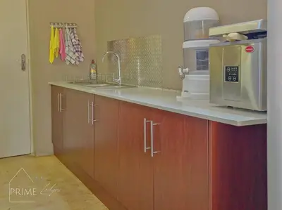 a kitchen with a sink and a microwave at Rhino Lodge at Zebula in Mabula