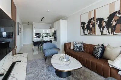 a living room with a couch and a table at Apartment Ellipse Waterfall in Midrand