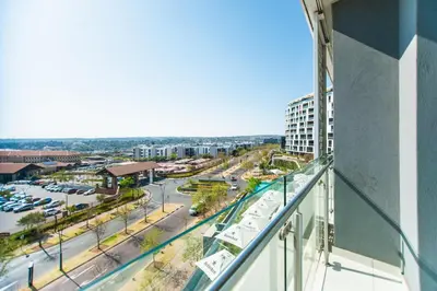 a view of a city from a balcony of a building at Apartment Ellipse Waterfall in Midrand