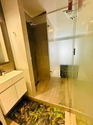a bathroom with a shower and a sink at Luxury Studio Apartment next to Brooklyn Mall in Pretoria