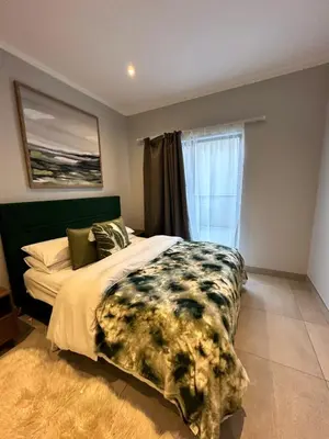 a bedroom with a bed and a window at Luxury Studio Apartment next to Brooklyn Mall in Pretoria