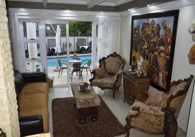 a living room with a couch and chairs and a table at The Lion Room at Frederick's Place in Pretoria