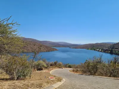 a road next to a body of water at Khenjadji at Fish Eagle Bay in Warmbaths