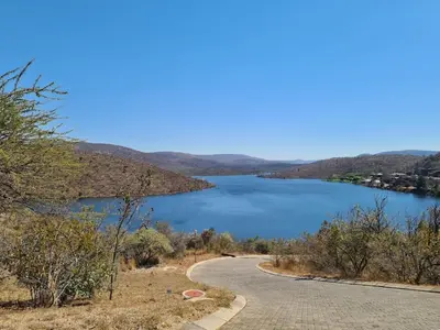 a road next to a body of water at Khenjadji at Fish Eagle Bay in Warmbaths