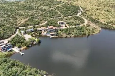 an aerial view of a house on a lake at Khenjadji at Fish Eagle Bay in Warmbaths