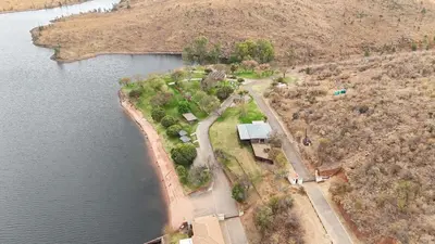 an aerial view of a house next to a lake at Khenjadji at Fish Eagle Bay in Warmbaths