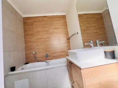 a bathroom with a sink and a bath tub at Tetani's Luxury Oasis in Lakeside