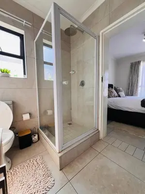 a bathroom with a shower with a glass door at Tetani's Luxury Oasis in Lakeside