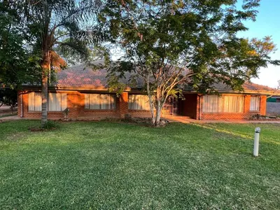 a brick house with a tree in the yard at Kremetart Villa in Alldays