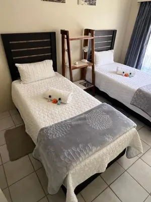 two beds sitting next to each other in a room at Kremetart Villa in Alldays