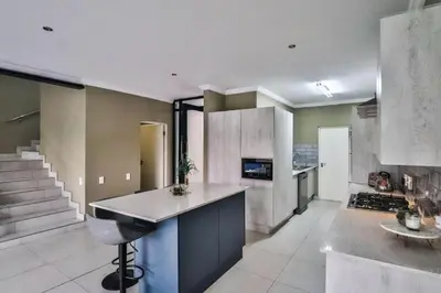 a kitchen with a counter top in a room at Hartbeespoort Dam Getaway Home in Kosmos