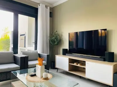 a living room with a large flat screen tv at Hartbeespoort Dam Getaway Home in Kosmos