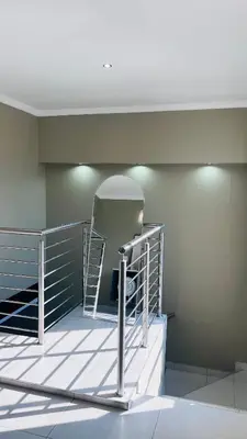 a room with a staircase and a mirror at Hartbeespoort Dam Getaway Home in Kosmos