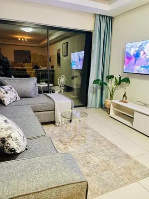 a living room with a couch and a table at The Classy West End 1 bed with sleeper couch in Midrand