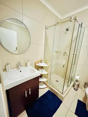 a bathroom with a sink and a shower at The Classy West End 1 bed with sleeper couch in Midrand