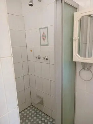 a bathroom with a shower with a toilet and a mirror at Whizzy lifestyle lodge in Duvhapark
