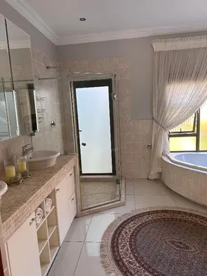 a bathroom with a tub and a sink and a shower at Pecanwood Holiday Home in Kosmos