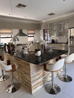 a kitchen with a large island with bar stools at Pecanwood Holiday Home in Kosmos