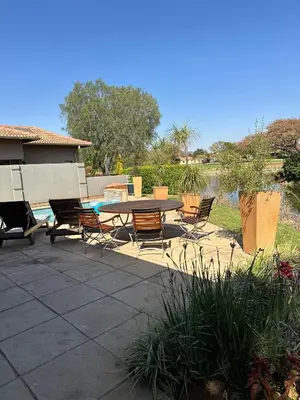 a patio with a table and chairs and a pool at Pecanwood Holiday Home in Kosmos