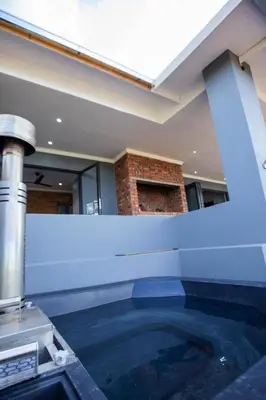 a swimming pool in the middle of a building at Sink Huis at Benlize in Pelindaba