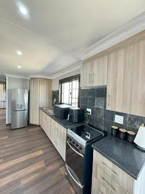 a kitchen with a stove and a refrigerator at Kings 93 Cabins in Tierpoort
