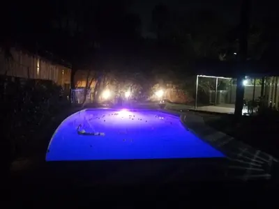 a blue pool at night with lights on it at Escape At House 68 in Pretoria