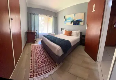 a bedroom with a large bed and a rug at Escape At House 68 in Pretoria