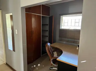 an office with a desk and a chair in a room at Escape At House 68 in Pretoria