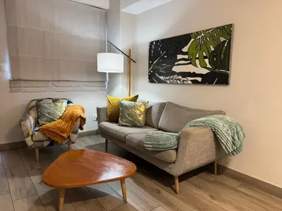 a living room with a couch and a table at Acoustic Apartment in Pretoria